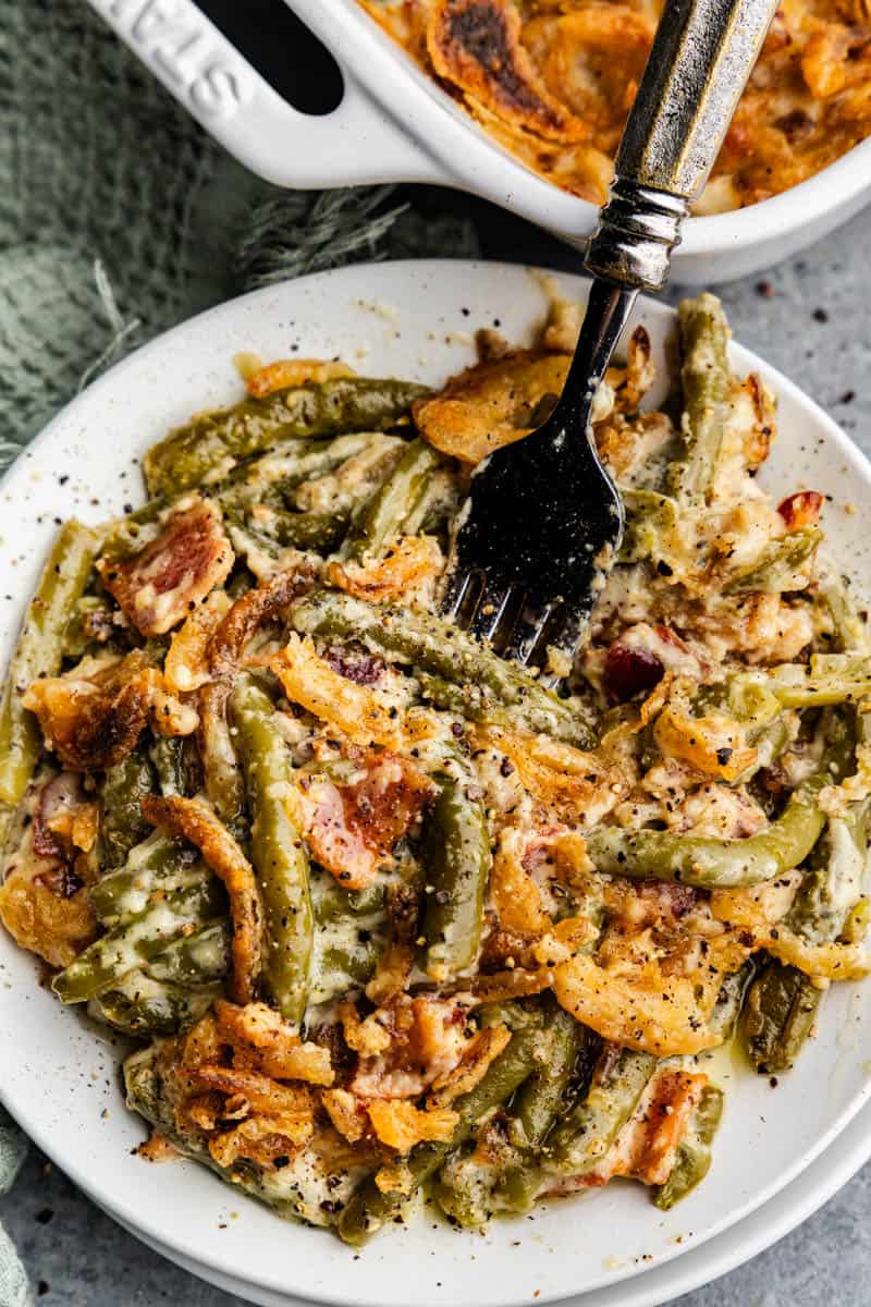 An overhead view of a plate of green bean casserole with a fork sticking out.