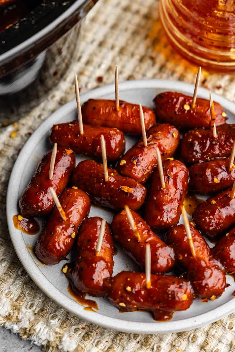 A platter of lil smokies with toothpicks sticking out.