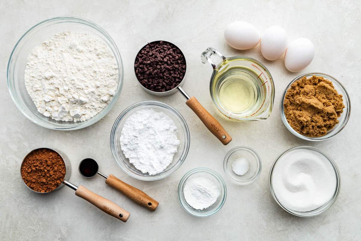 An overhead view of the ingredients needed to make chocolate crinkle cookies.