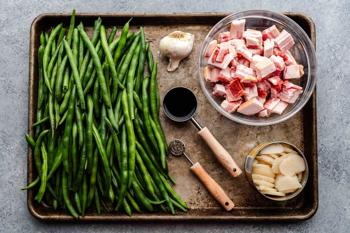 sauteed green bean ingredients on large cookie sheet