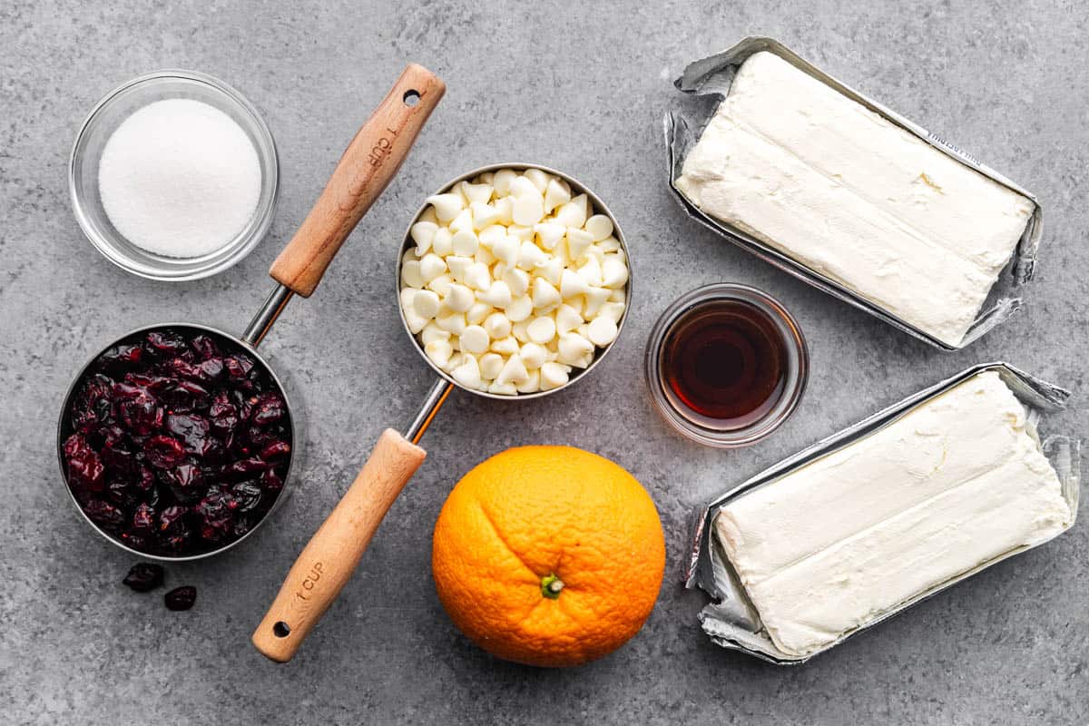 An overhead view of the measured ingredients needed to make a white chocolate cranberry orange cheese ball.