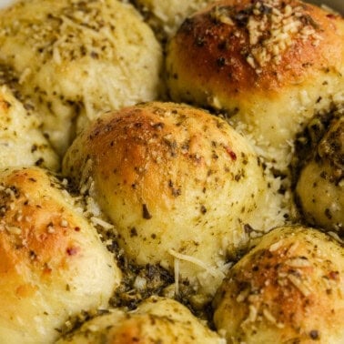 an overhead view of pesto parmesan rolls in a pan