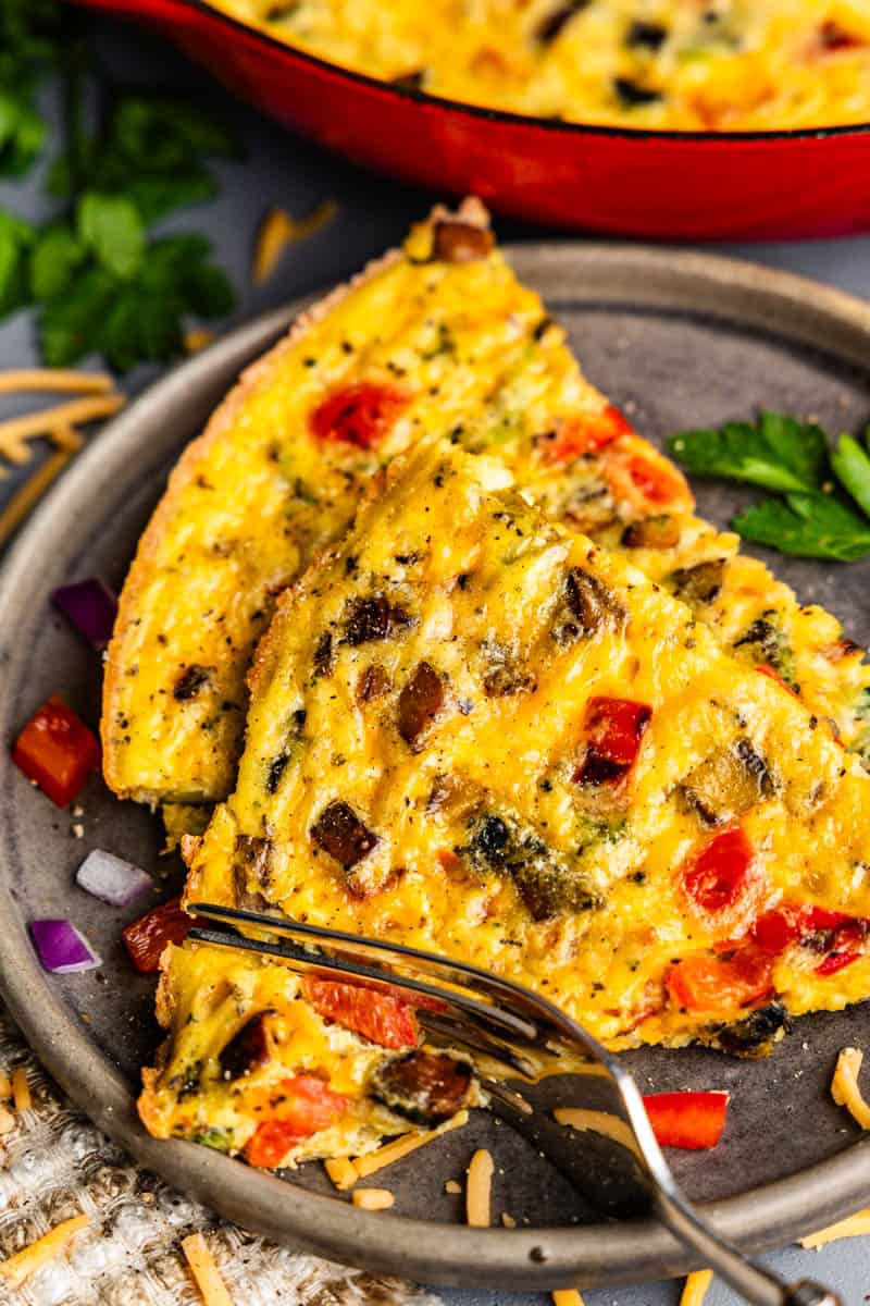 Two slices of a veggie frittata on a plate.