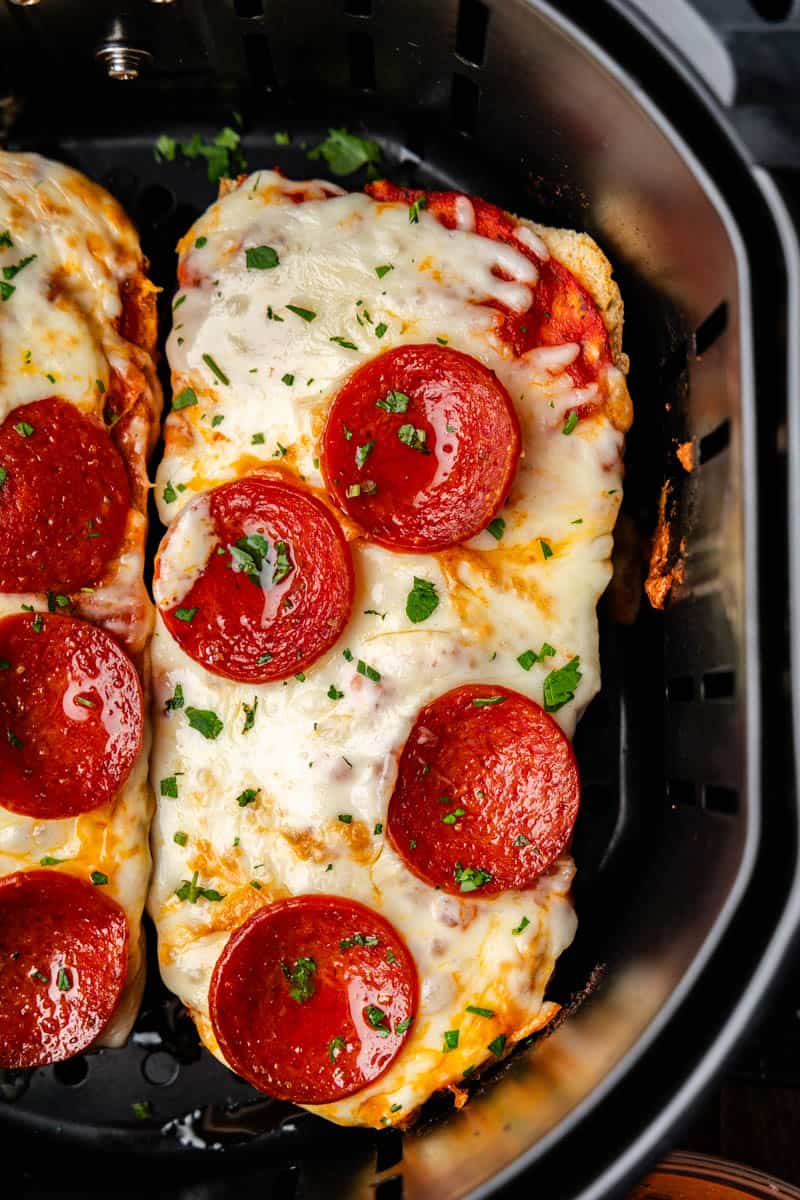 An overhead view of a slice of Air Fryer French Bread Pizza in the air fryer.