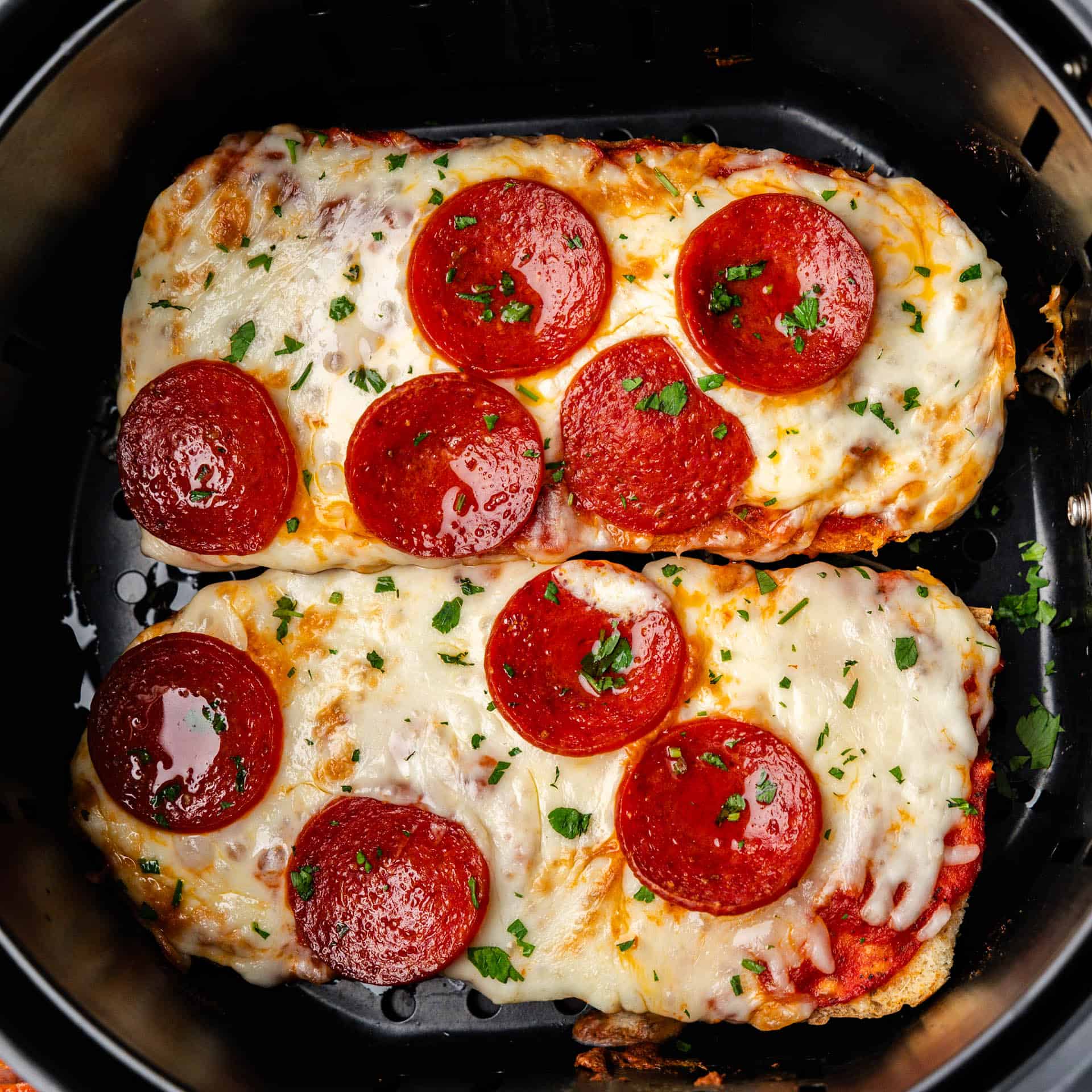 An overhead shot of two slices of air fryer french bread pizza.