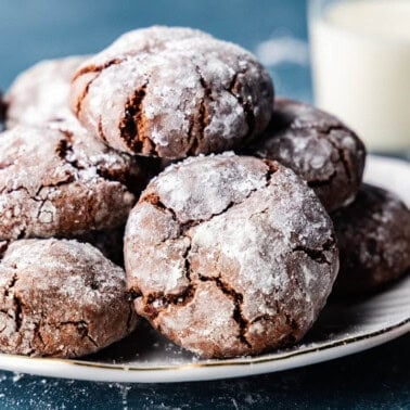 A plate of chocolate crinkles cookies piled high.