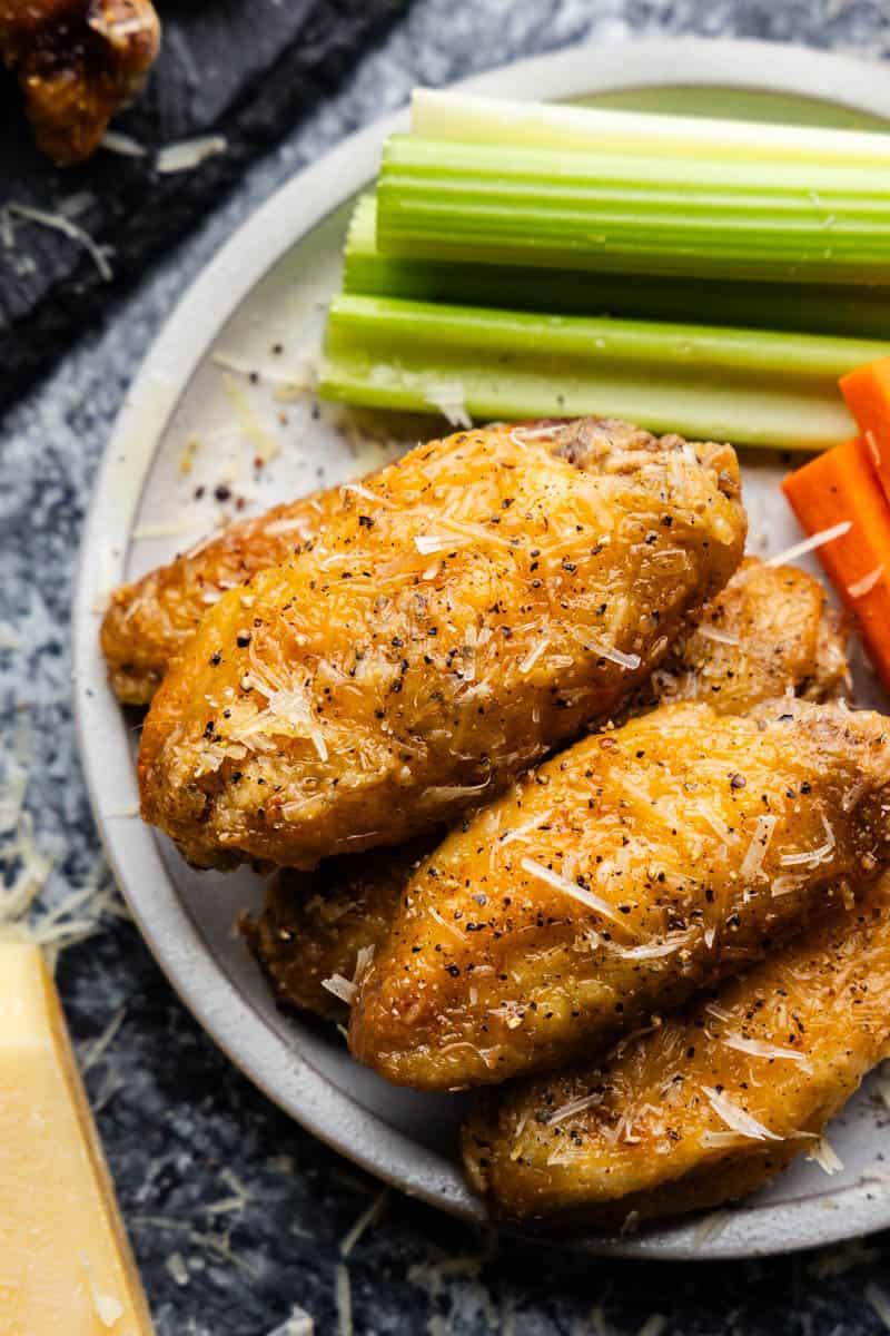 An overhead view of a plate of garlic parmesan chicken wings.