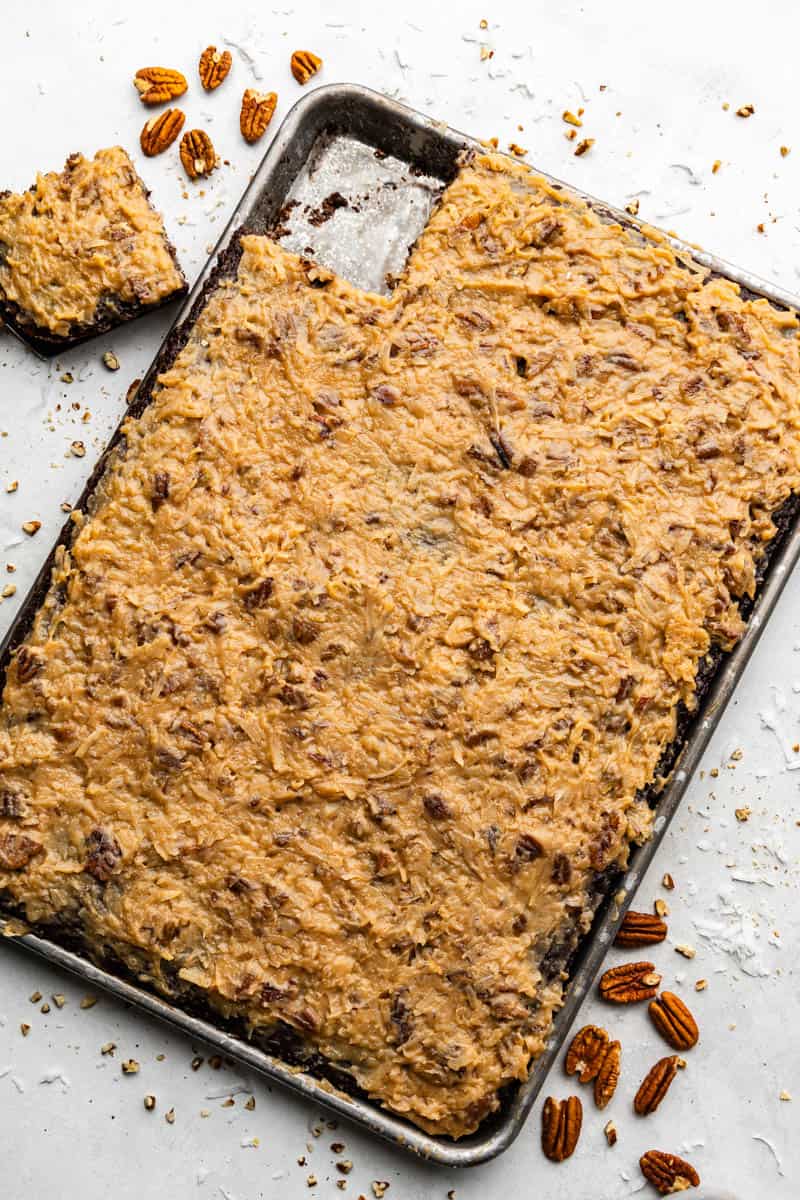 top view of german chocolate sheet cake in pan with slice taken out