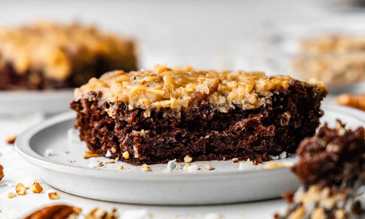 slice of german chocolate sheet cake on white plate