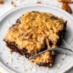 slice of german chocolate sheet cake on plate with fork