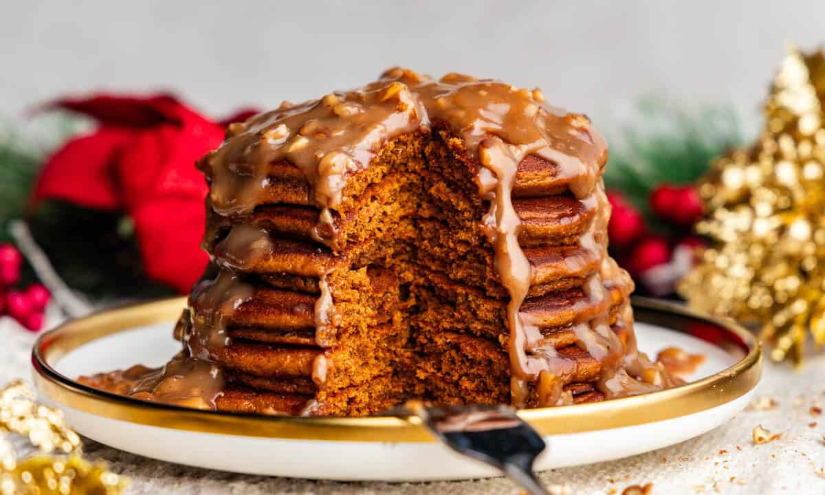 stack of gingerbread pancakes with butter pecan syrup on a plate