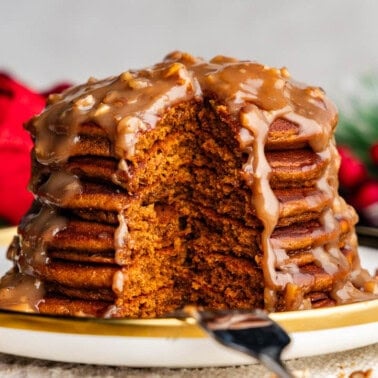 stack of gingerbread pancakes with butter pecan syrup on a plate