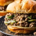 side view of a cheesesteak sloppy joe on a plate