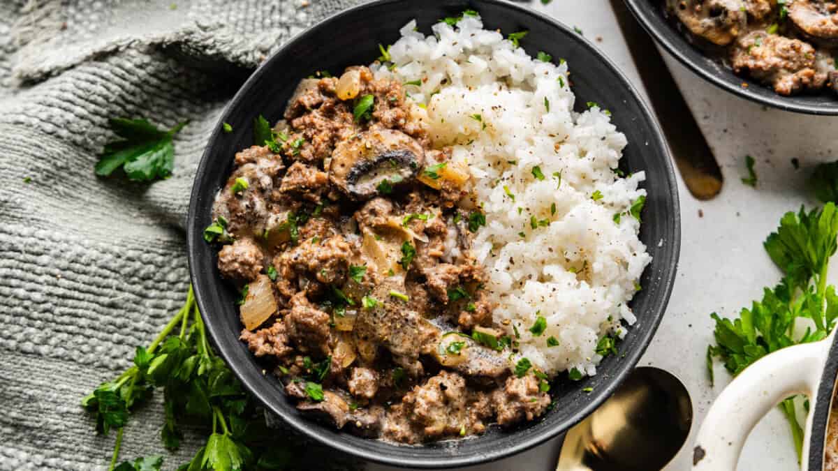 An overhead view of a bowl of ground beef stroganoff and rice.