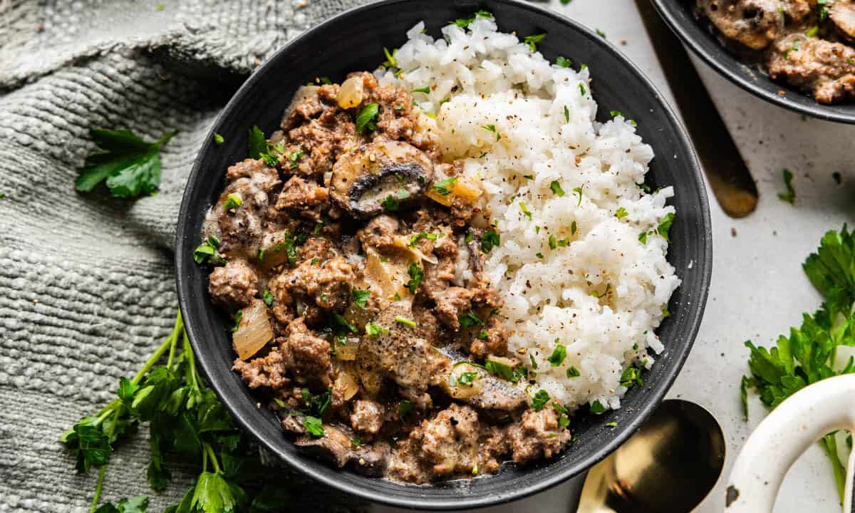 An overhead view of a bowl of ground beef stroganoff and rice.