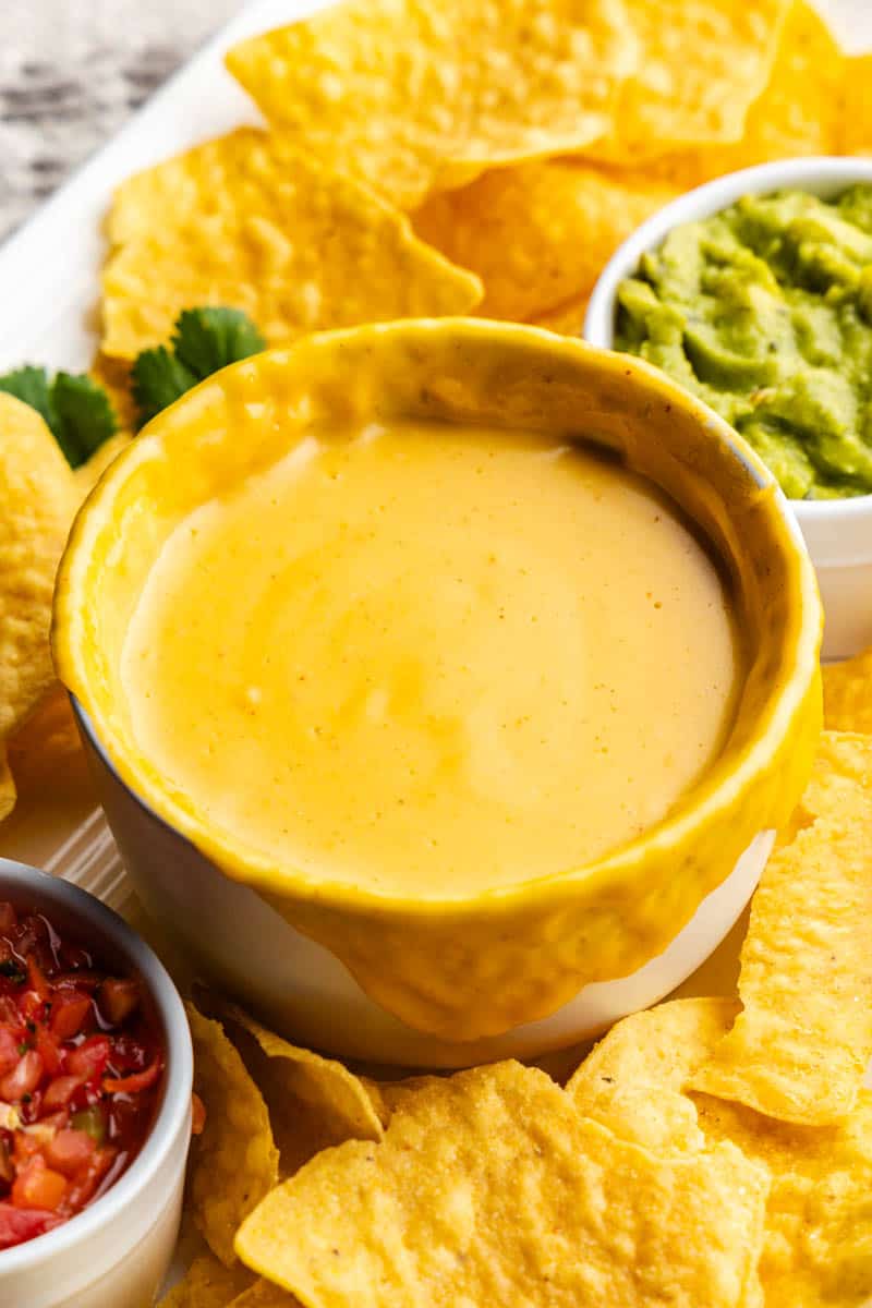 side view of bowl of homemade nacho cheese sauce