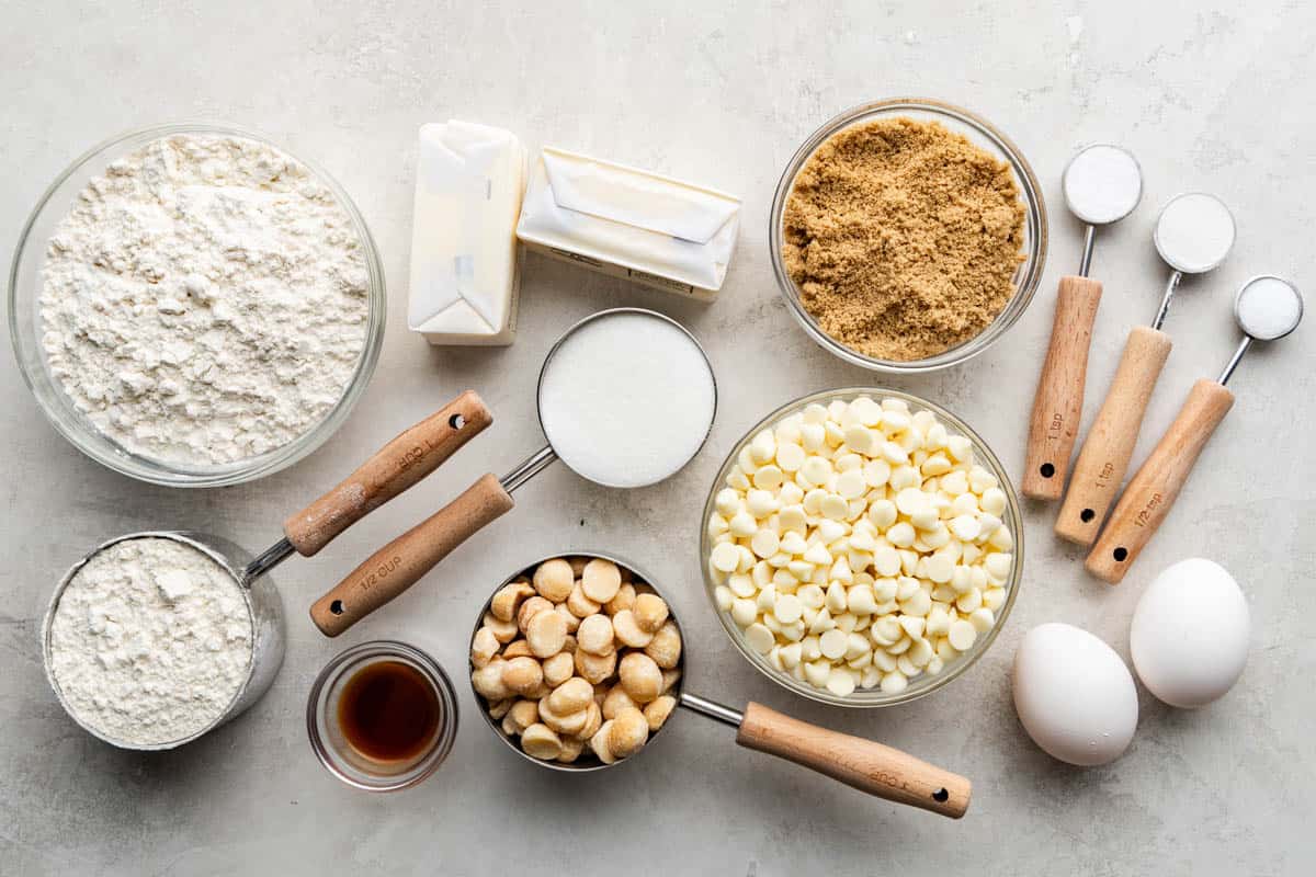 An overhead view of the ingredients needed to make bakery style white chocolate macadamia nut cookies.