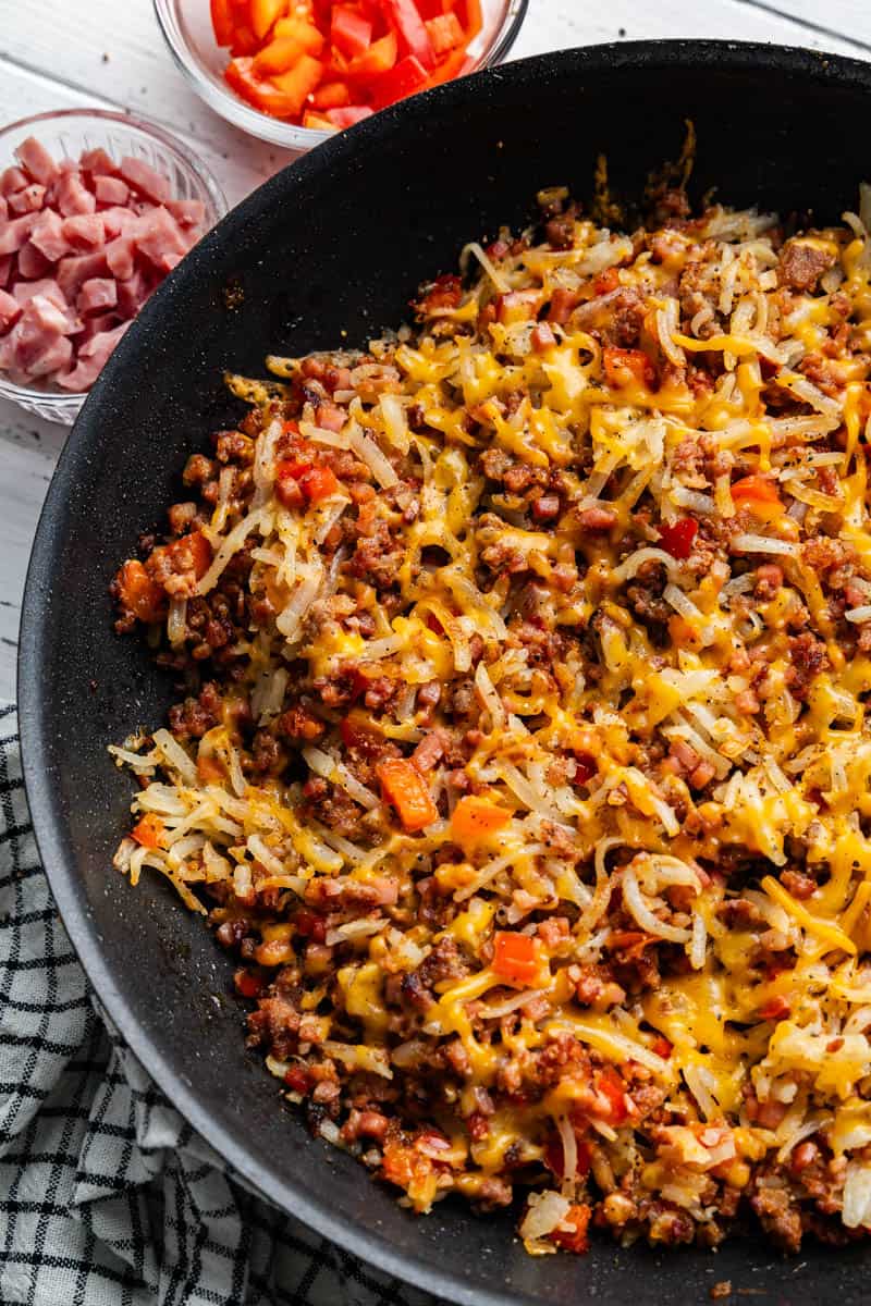 A top view into a skillet of loaded breakfast hash.