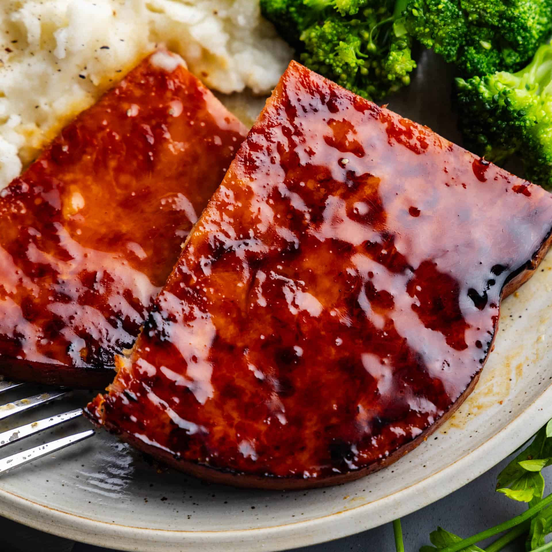 up close view of slice of maple and mustard glazed ham steak