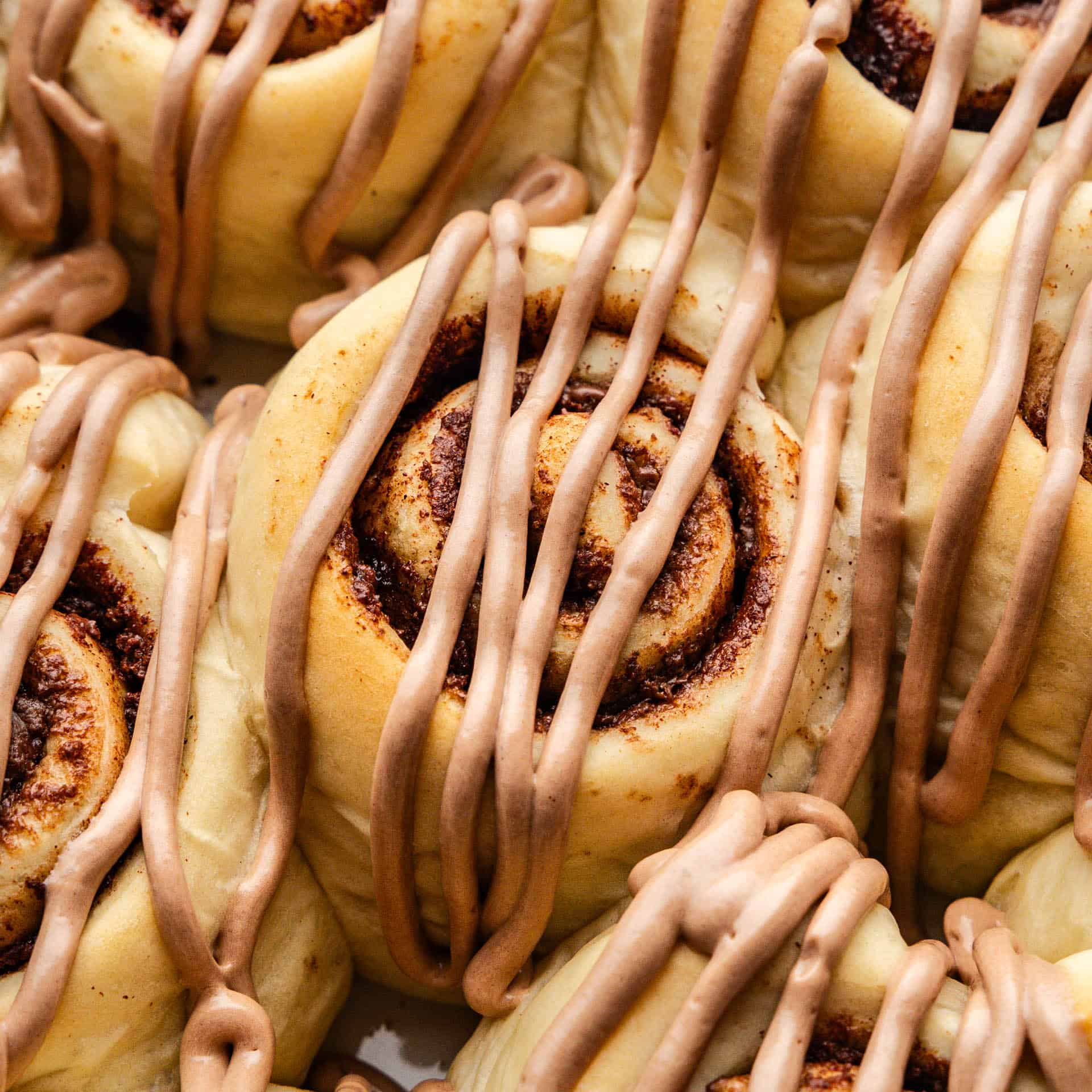 A close up view of Nutella cinnamon rolls in a pan.