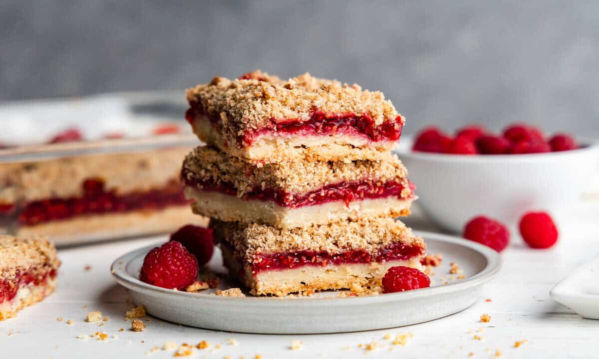 stack of raspberry streusel dessert bars on round plate