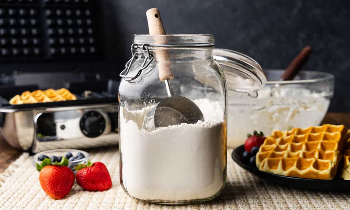 A large glass jar of homemade waffle mix.