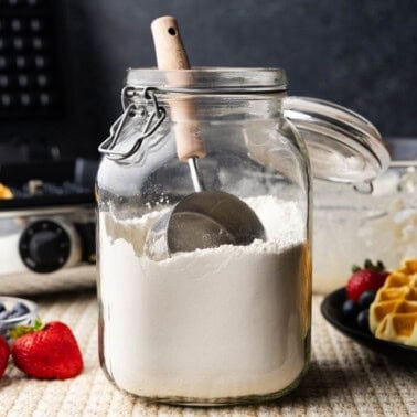 A large glass jar of homemade waffle mix.