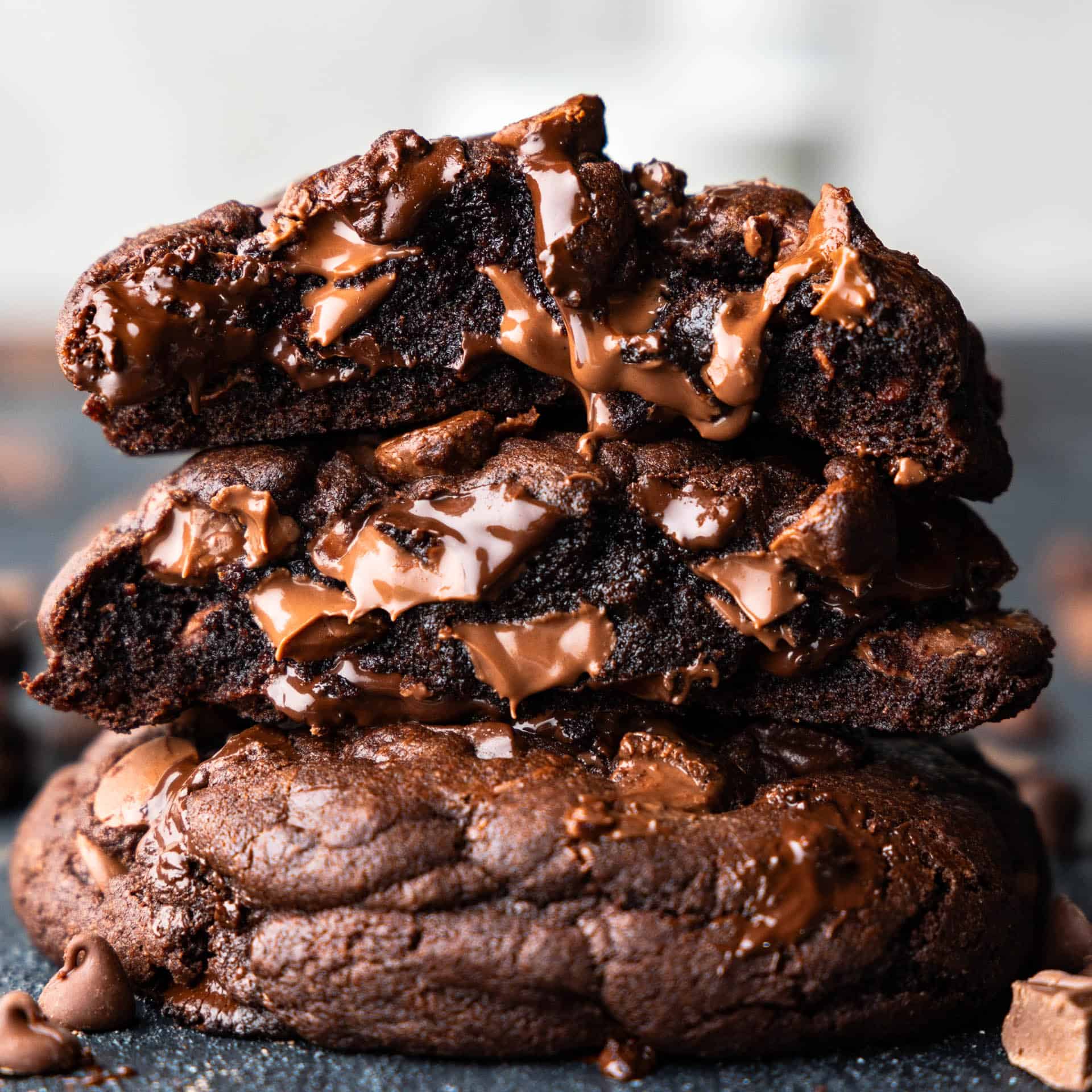 A stack of 3 ooey gooey chocolate chunk cookies.