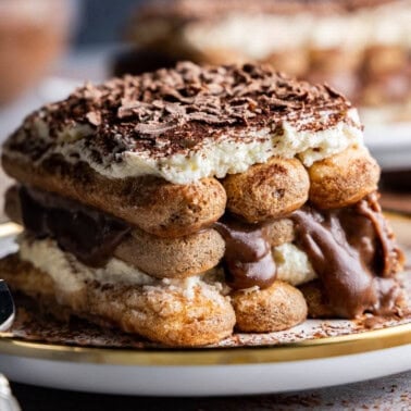 Angled shot of tiramisu slice on a plate with a fork.