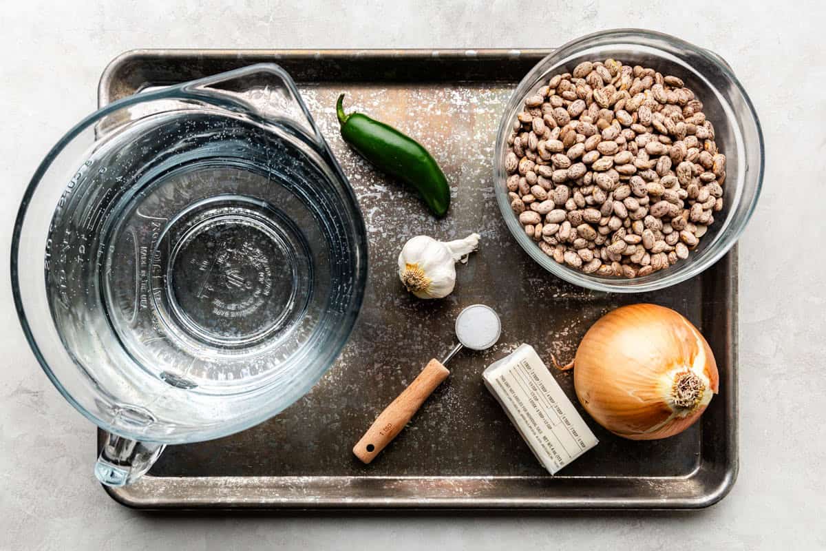 An overhead view of the ingredients needed to make Slow Cooker Mexican Refried Beans.