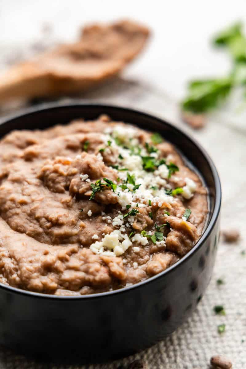 Closeup shot of cooked pinto beans in bowl.