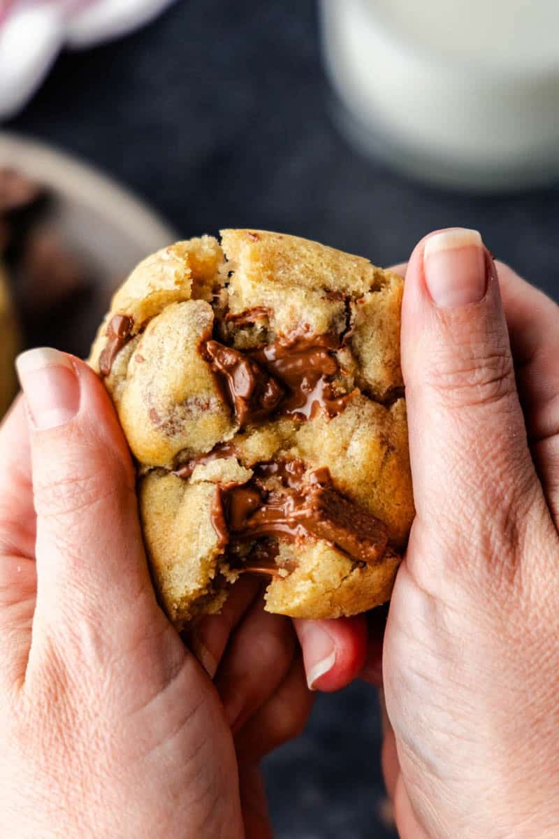 Chocolate chip air fryer cookie being pulled apart.