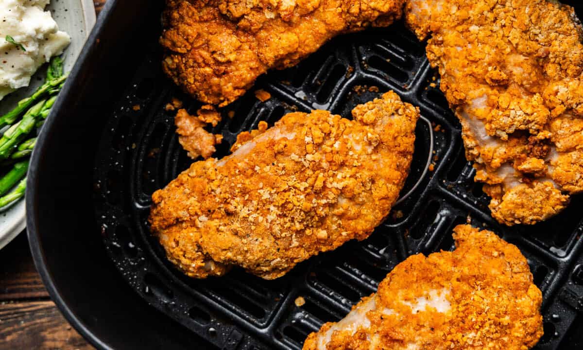 Overhead shot of Air fryer crispy pork chops in air fryer.