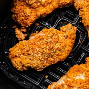 Overhead shot of Air fryer crispy pork chops in air fryer.