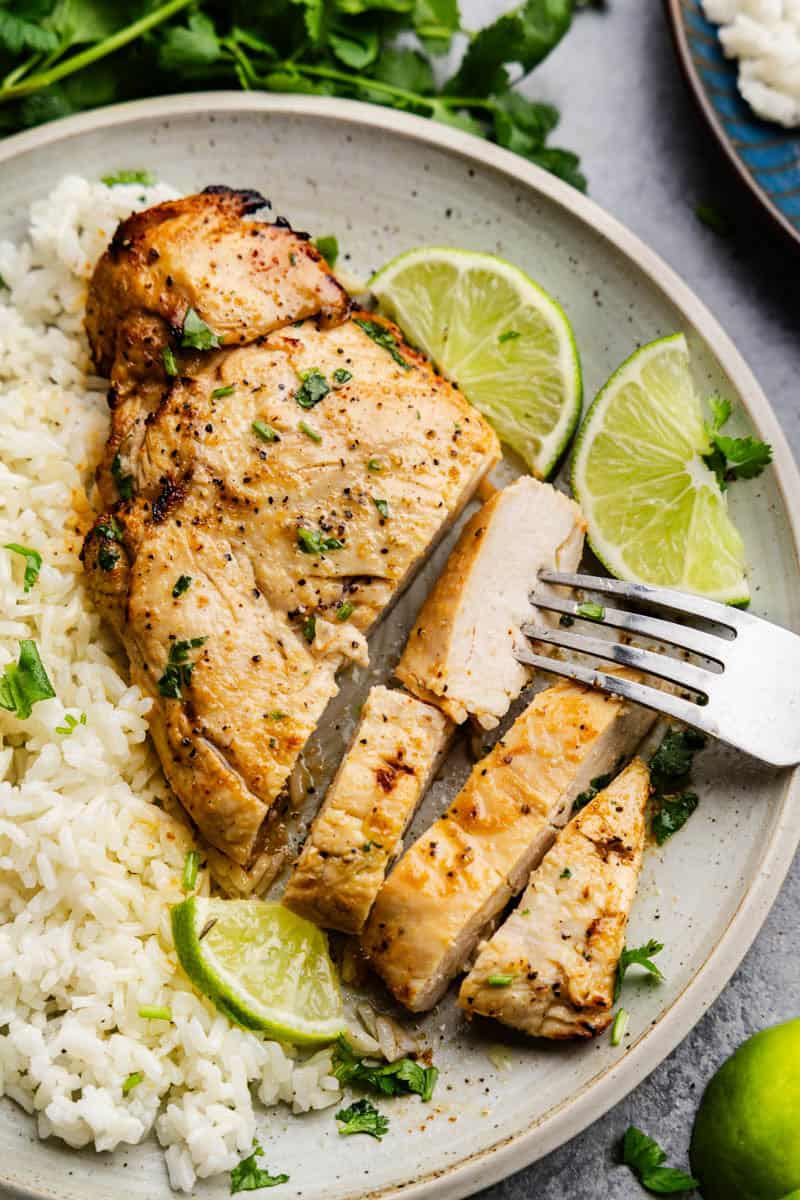 Closeup of Garlic Lime Chicken cut up on a plate.