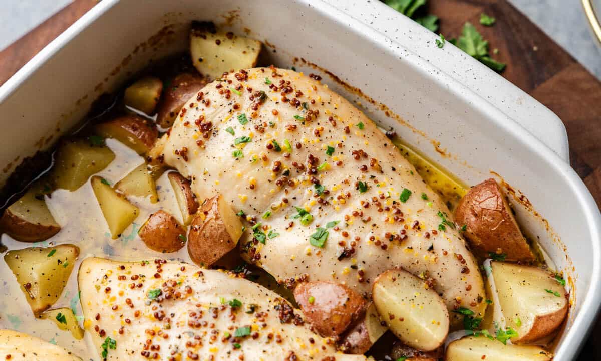 Baked Honey Dijon Chicken and Potatoes in casserole dish.