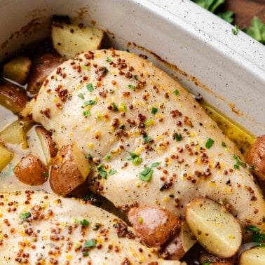 Baked Honey Dijon Chicken and Potatoes in casserole dish.