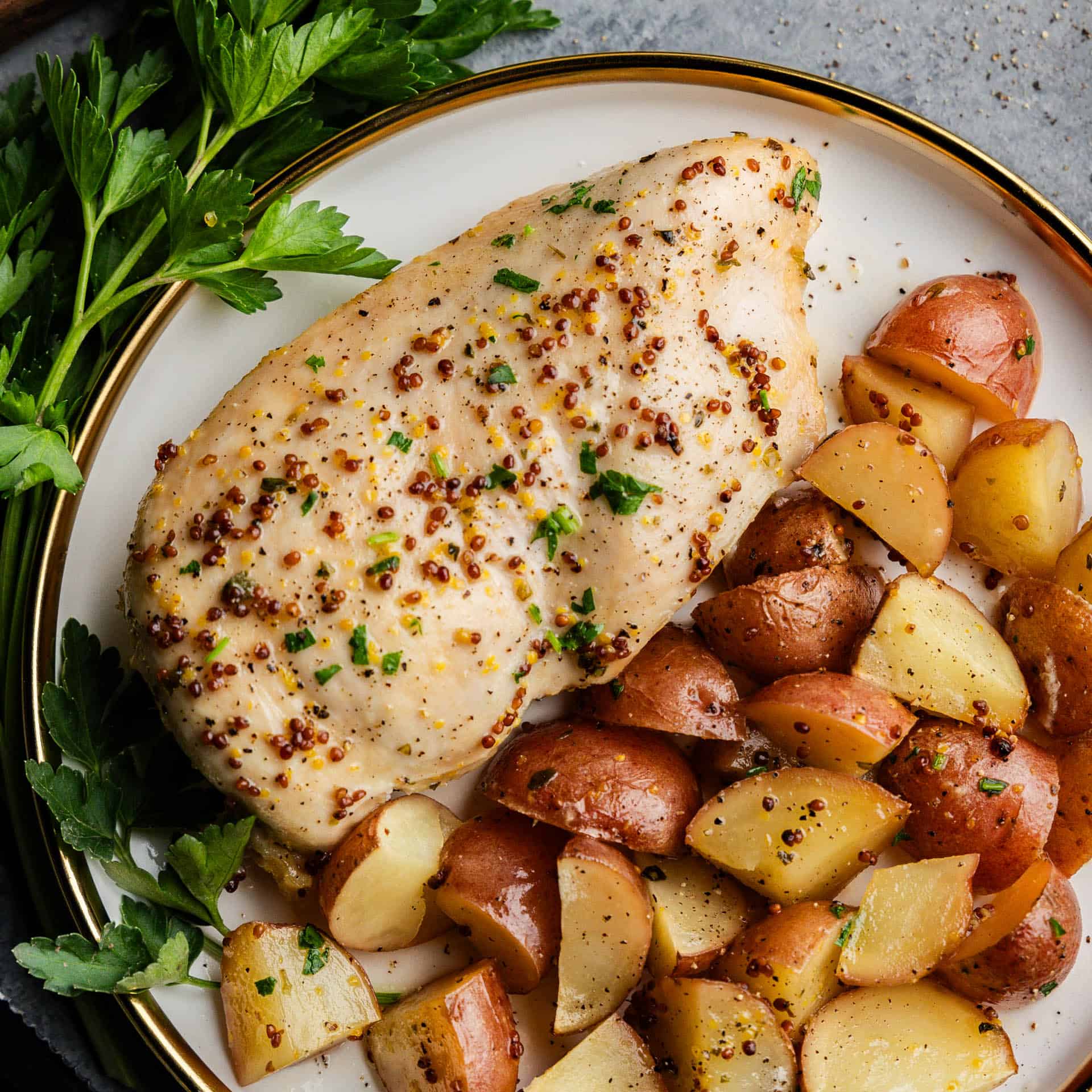 Baked Honey Dijon Chicken and Potatoes on a plate with mini potatoes.