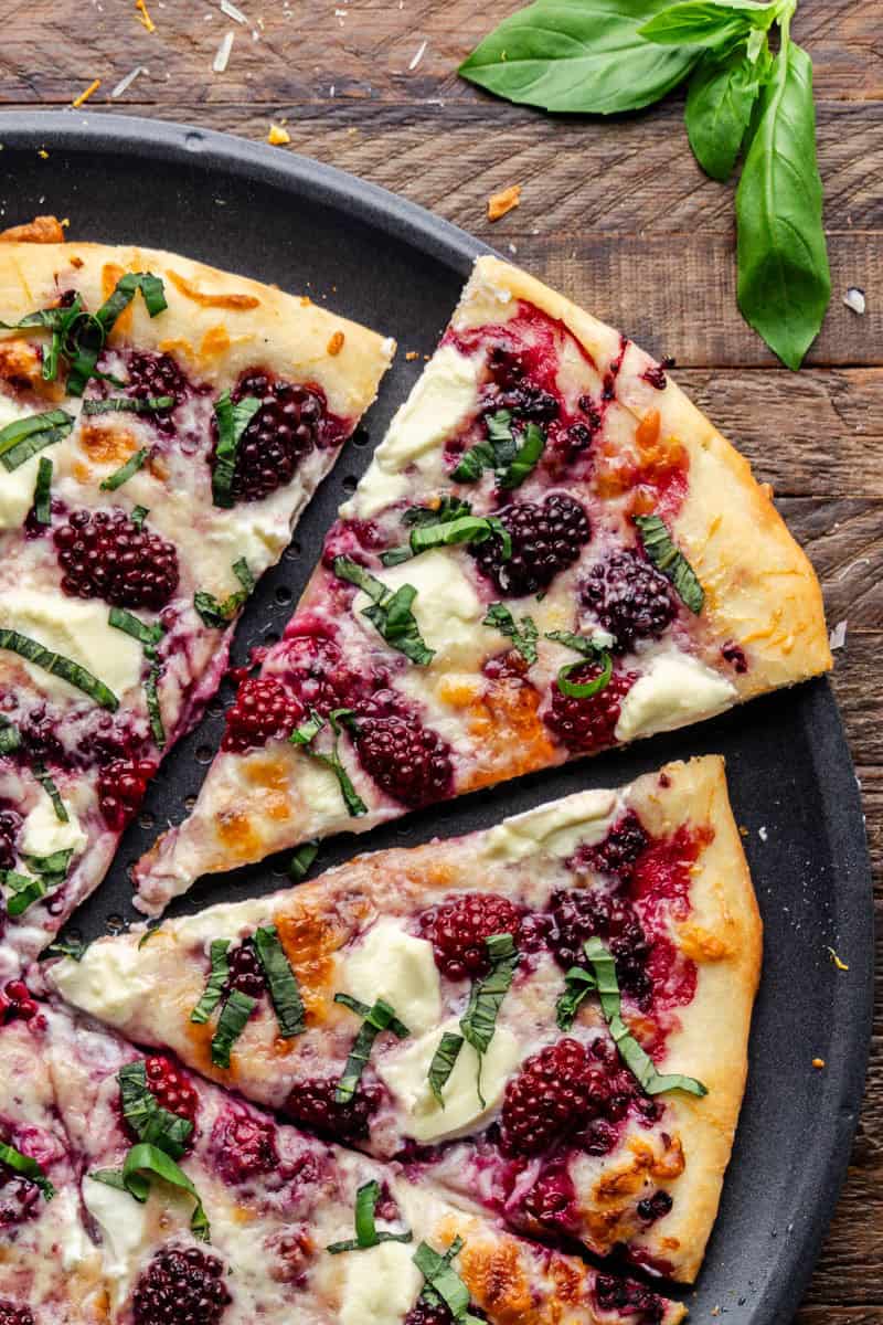 Overhead view of a slice of Blackberry Basil Ricotta Pizza.