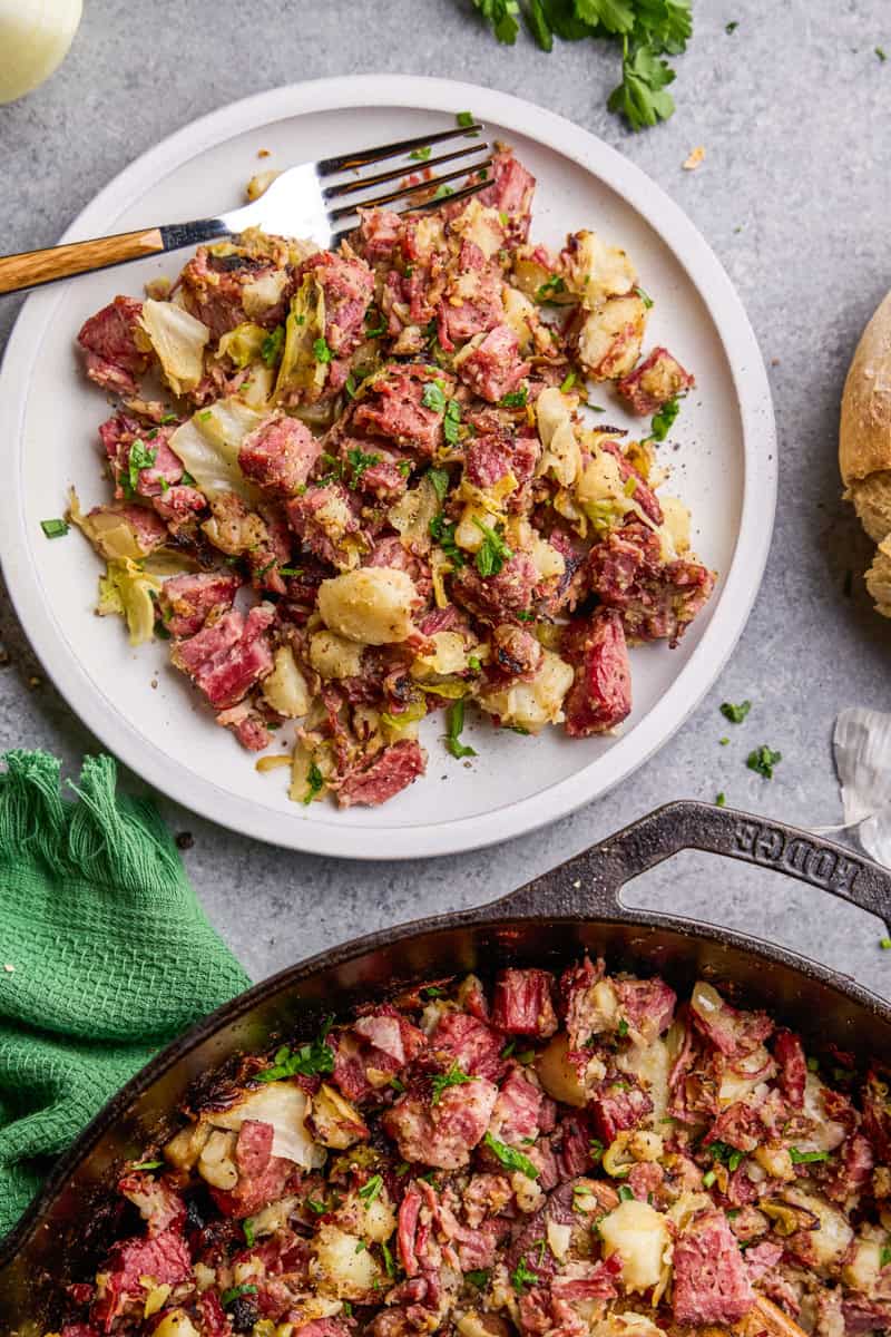 Overhead image of Corned Beef Cabbage Hash on a plate with cast iron skillet.