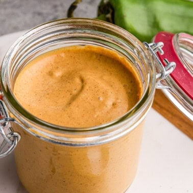 Cowboy Dressing in a glass jar with ingredients surrounding it.