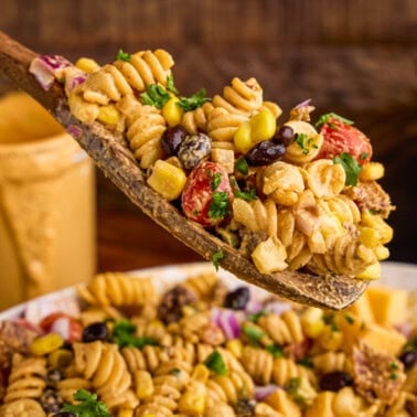 A wooden spoonful of Cowboy Pasta Salad.