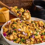 A wooden spoonful of Cowboy Pasta Salad.