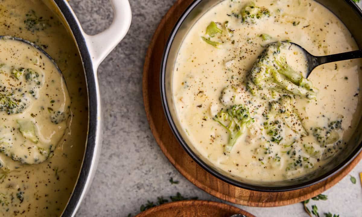 Bowl of Easy Broccoli Cheddar Soup with spoon in it.