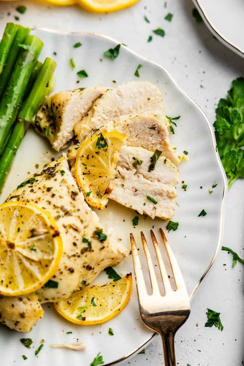 Lemon Herb Baked Chicken Breasts on a plate with fork.