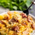 A close up image of a fork full of Ham & Potato Casserole.