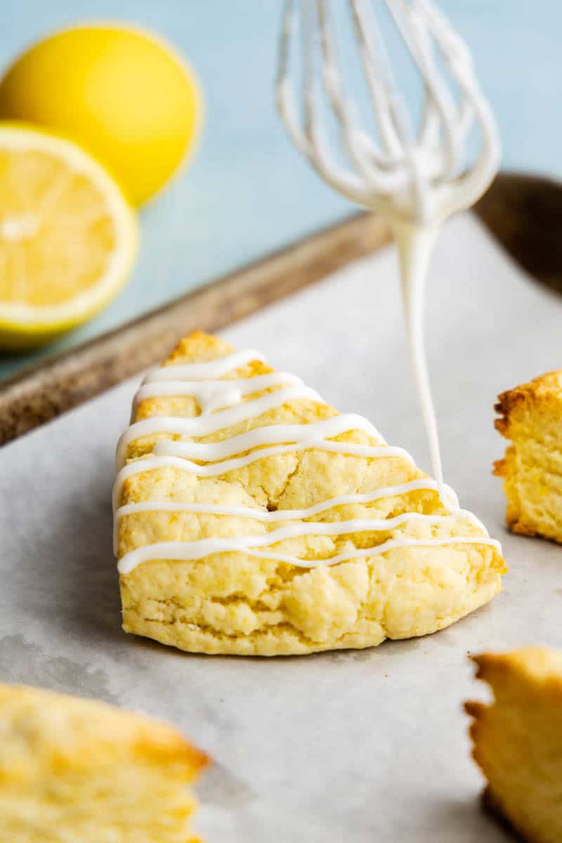 Closeup of a Lemon Scone on a cookie sheet being drizzled on.