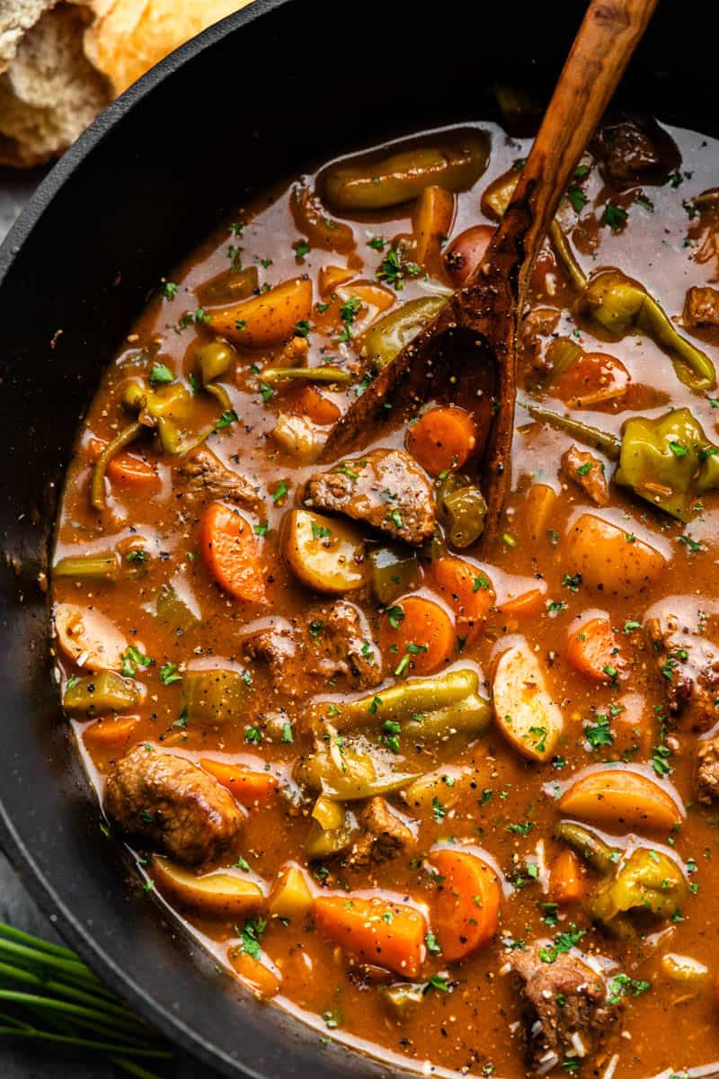 Overhead shot of Mississippi Beef Stew stirred with a ladle.