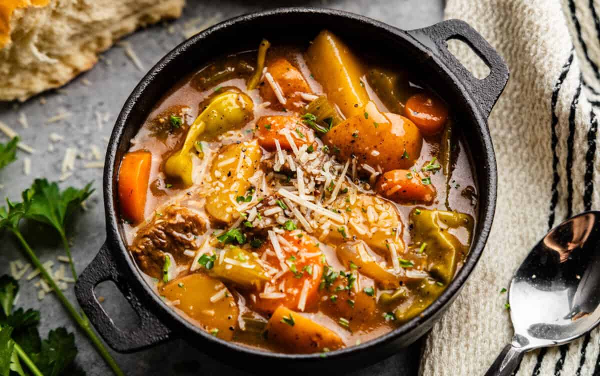 Closeup of Mississippi Beef Stew in a bowl topped with parmesan cheese.