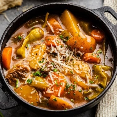 Closeup of Mississippi Beef Stew in a bowl topped with parmesan cheese.